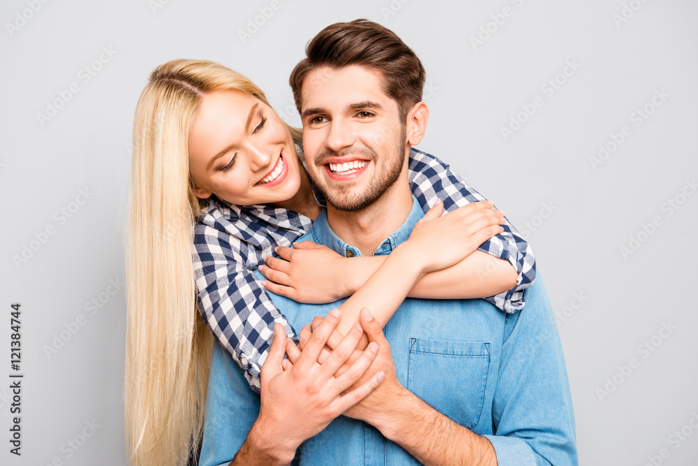 Smiling man piggybacking his girl and she huging him Smiling man piggybacking his girl and she huging him