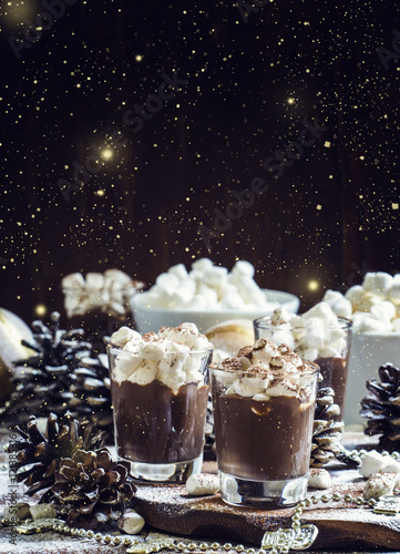 Hot chocolate with marshmallows in a xmas decoration with snowfl