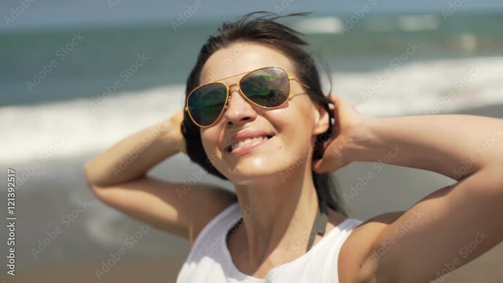 Happy woman relaxing, enjoying sunny day on beach
