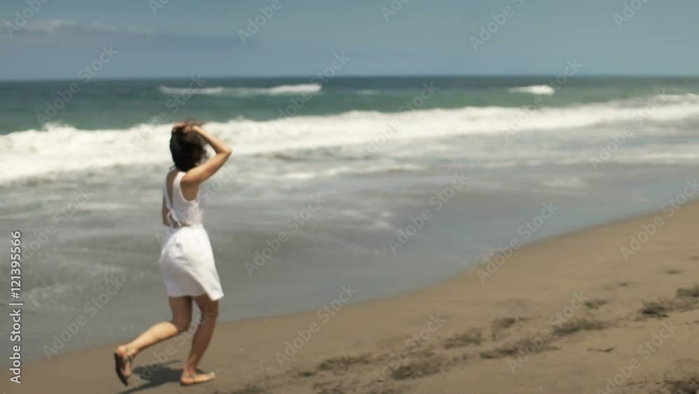 Happy woman running on beach near sea
Happy woman running on beach near sea