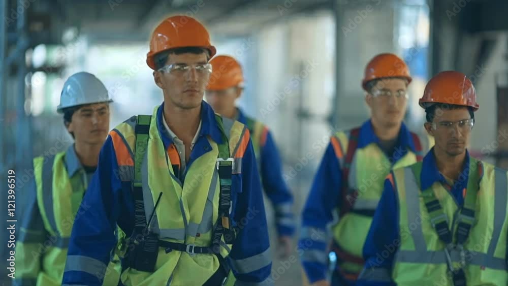 workers and engineers, walking on industrial factory.