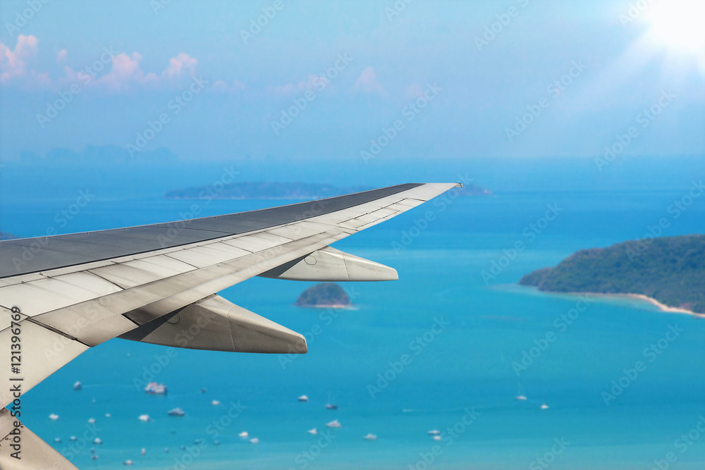 Airplane flying over sea blue island - Trave Concept