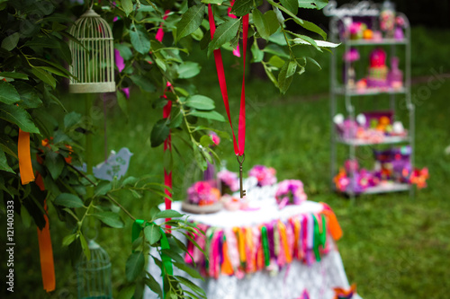 Wedding decoration with flowers and colorful ribbons on the tree