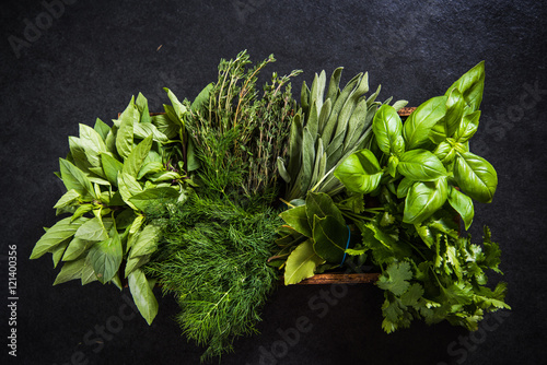 Fresh herbs in wooden rustic box photo