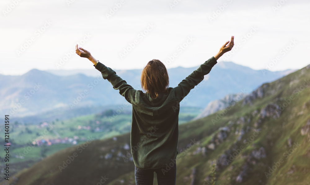 Happy tourist traveler standing on a rock with raised hands, hiker looking to a valley below in trip in spain, hipster young girl enjoying peak of foggy mountain background landscape view mockup Happy tourist traveler standing on a rock with raised hands, hiker looking to a valley below in trip in spain, hipster young girl enjoying peak of foggy mountain background landscape view mockup