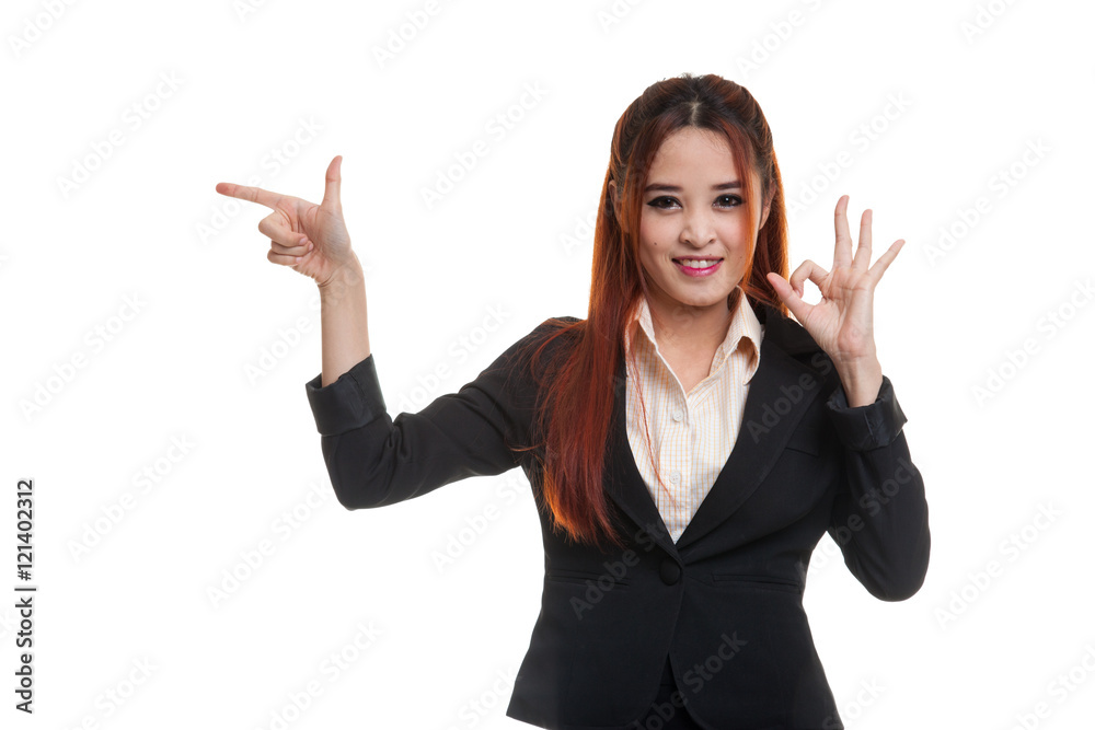 Young Asian business woman point and show OK. Young Asian business woman point and show OK.