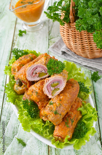 Meat rolls stuffed with bacon and pickled cucumber
