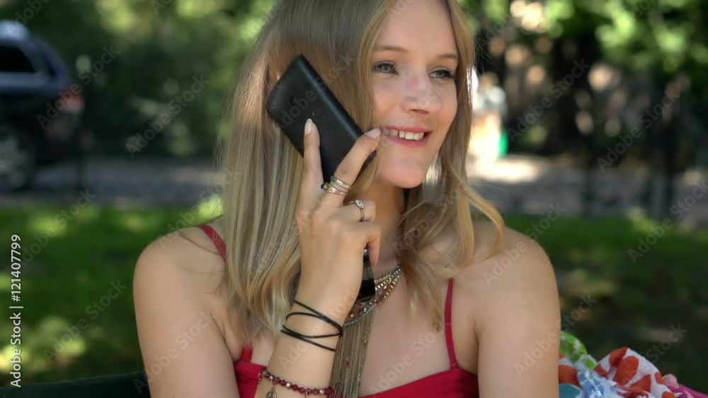 Beautiful girl smiling while talking on cellphone, slow motion shot
Beautiful girl smiling while talking on cellphone, slow motion shot