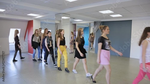 Group of girls trains in defile in dancing class.