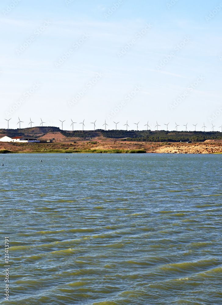 The Tranquera reservoir with windmills in the background, Spain