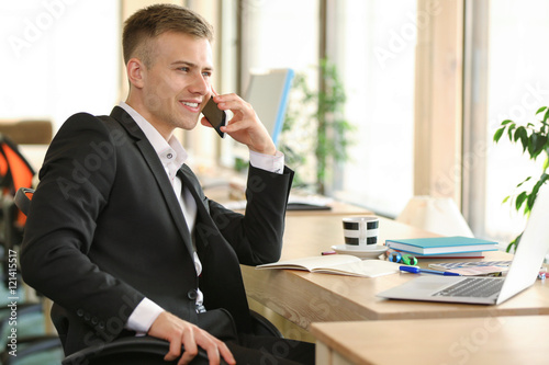 Young man speaking by cellp...