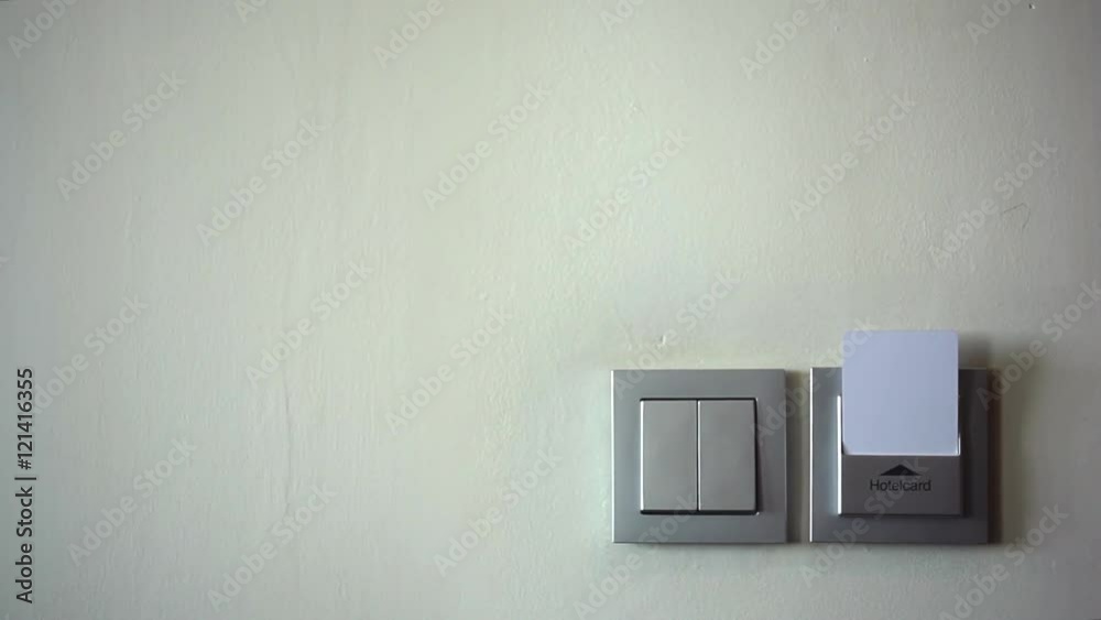 The Key to the Room - Access to the Service of the Hotel/Female hand inserts an electronic room key. Lights on. She removed the key - the lights go out The Key to the Room - Access to the Service of the Hotel/Female hand inserts an electronic room key. Lights on. She removed the key - the lights go out