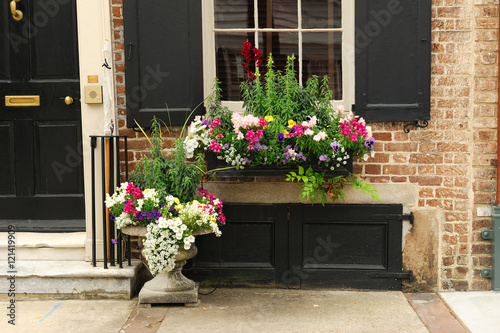 close up on window decorated with flower and flowerbox