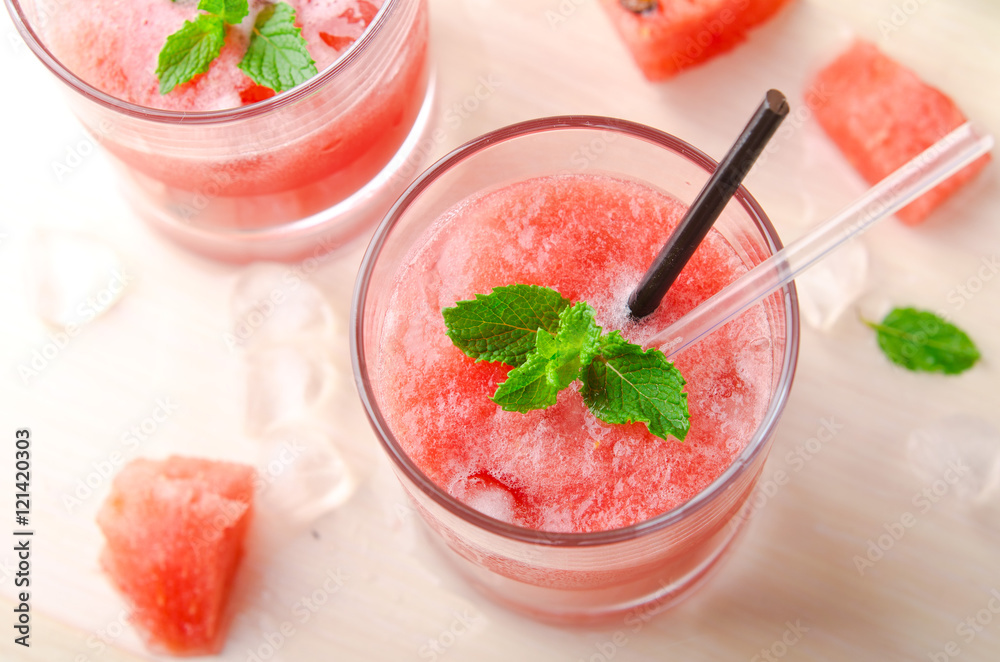 Healthy watermelon smoothie with mint and ice in glass Healthy watermelon smoothie with mint and ice in glass
