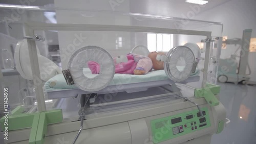 Doll in an incubator for premature babies photo