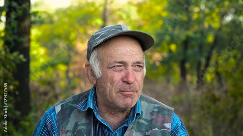 Old man drinks tea. Portrait of middle-aged man. Old man drinks tea. In the background of green forest. 4K photo