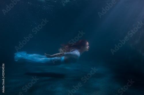 Woman as the mermaid under water.