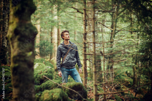 Young man walking in the woods