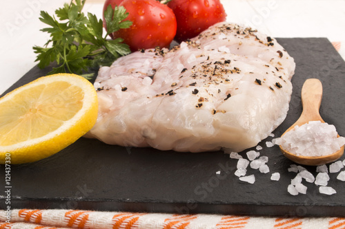 hake fillet with coarse sea salt, a slice of lemon, parsley and