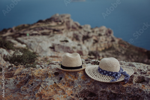 two hats on vacation in mountains