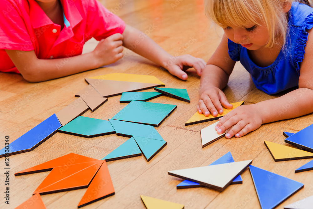 kids learning -little boy and girl playing with geometric shapes kids learning -little boy and girl playing with geometric shapes