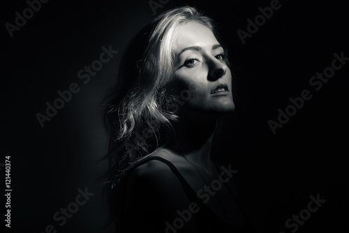 Portrait of a beautiful blonde on a black background