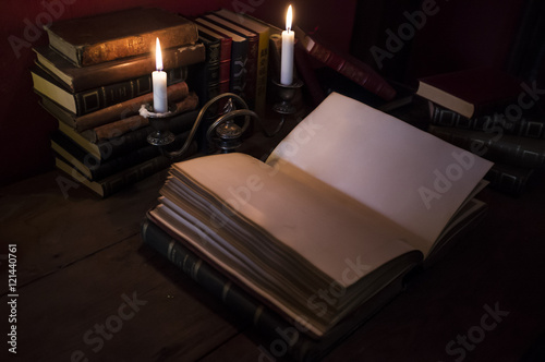 Old Book Lit Up With Candles