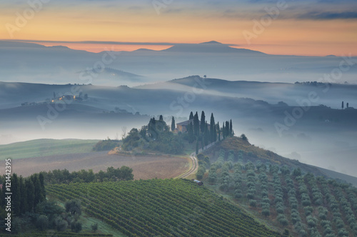 Tuscany. Image of Tuscany landscape during foggy autumn sunrise.