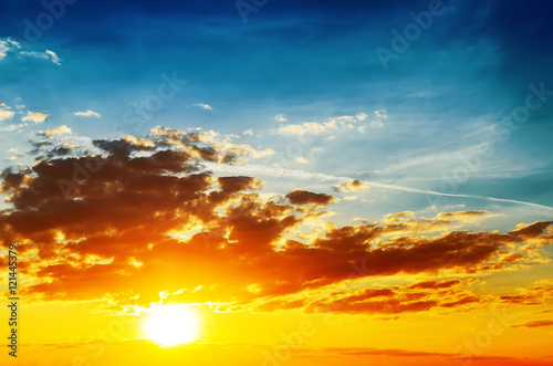 bright orange sunset and low dark clouds