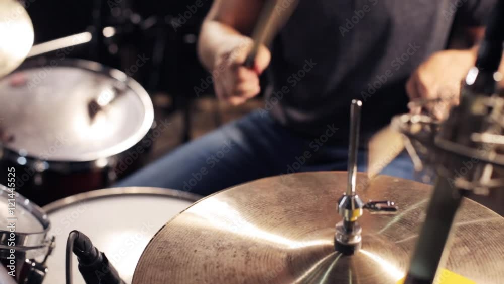 male musician playing drums and cymbals at concert male musician playing drums and cymbals at concert