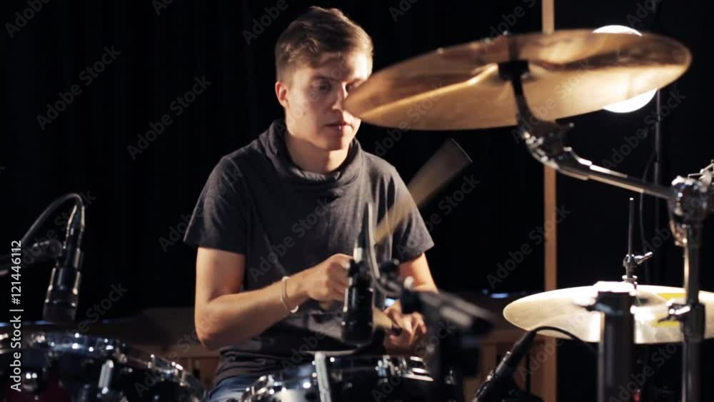 male musician playing drums and cymbals at concert male musician playing drums and cymbals at concert