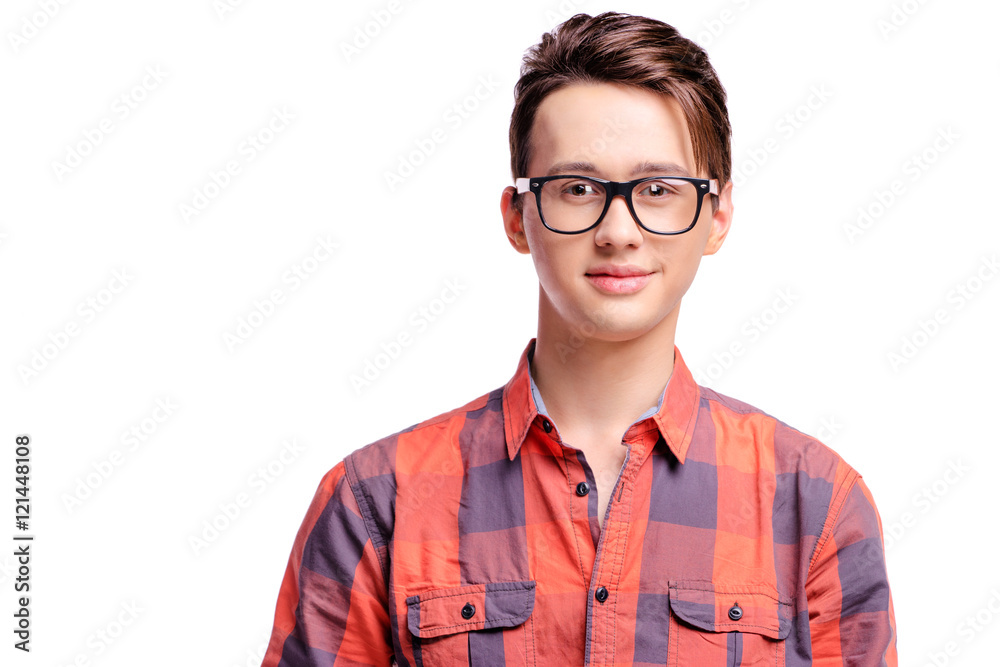 Close up studio portrait of handsome young man in red plaid shirt and eyeglasses. Isolated on white.