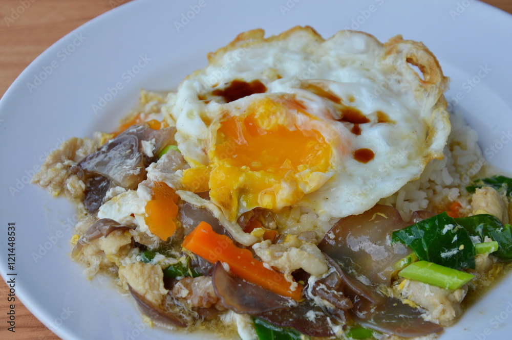 stir fried pork with vegetable in gravy sauce and creamy egg yolk on rice stir fried pork with vegetable in gravy sauce and creamy egg yolk on rice