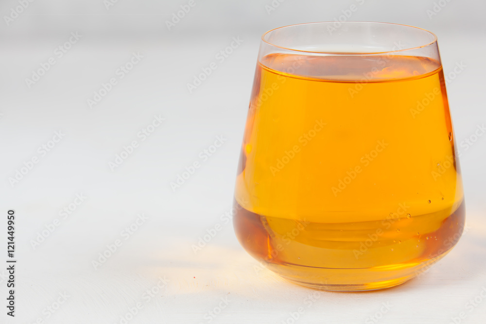 Delicious fresh squeezed apple juice in transparent glass Delicious fresh squeezed apple juice in transparent glass