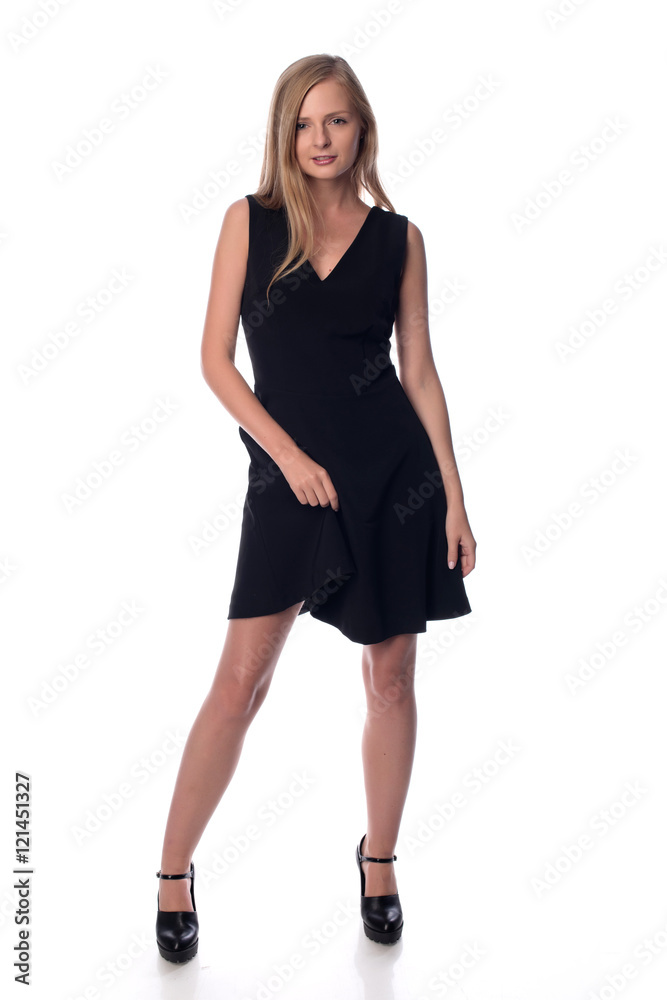 Young pretty long haired blonde woman posing in fashion dress on white background in a studio. Spring summer photo, catalog collection. Young pretty long haired blonde woman posing in fashion dress on white background in a studio. Spring summer photo, catalog collection.