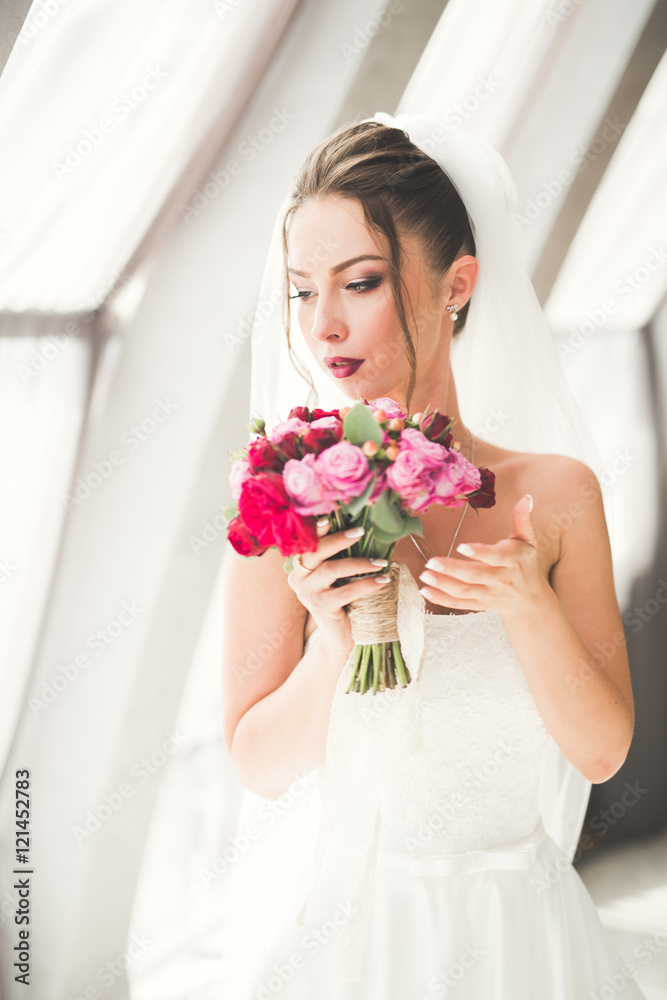 Beautiful bride with wedding bouquet posing in old city Beautiful bride with wedding bouquet posing in old city