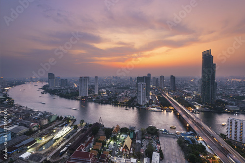 Photography Skyscraper on night scene cityscape at Chaopraya river in Bangko
