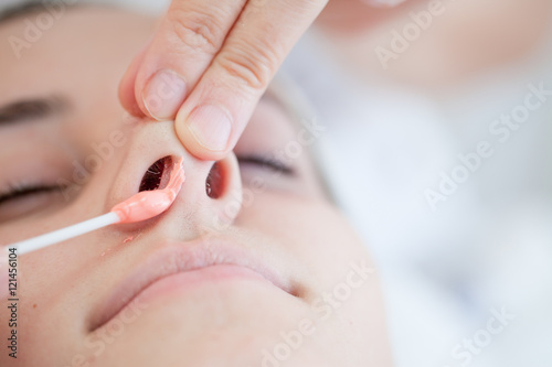 Nasal hair remover with hot wax,Beautician removes nasal hair with hot wax