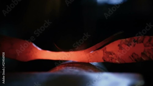 forging hot metal on the anvil