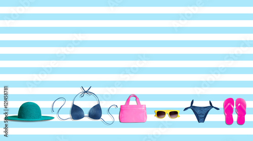 Summer fashion items isolated on light blue stripe. copy space. 