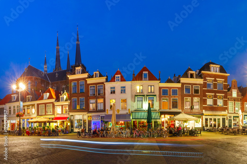 Panorama wiyh typical Dutch houses on the Markt square in the center of the old city at night, and Maria van Jessekerk on the background, Delft, Holland, Netherlands