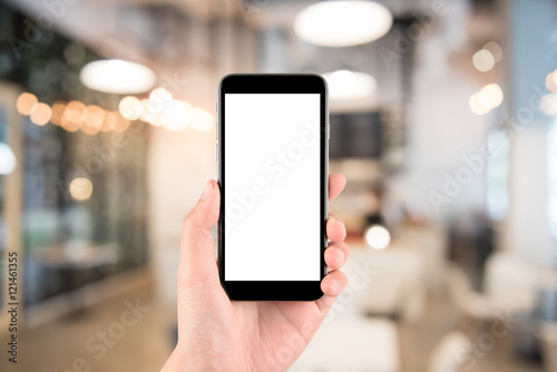 hand holding the phone tablet on blurred in shop or restaurant background;Transactions by smartphone concept