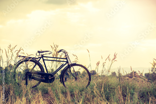 beautiful landscape image with vintage Bicycle at sunset,classic