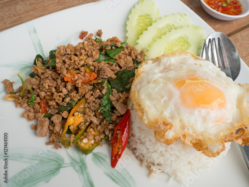 Close up Rice topped with stir fried minced pork,basil and fried photo