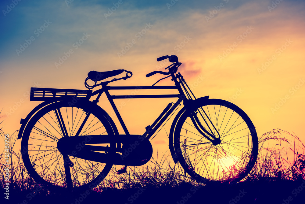 beautiful landscape image with Silhouette Bicycle at sunset in beautiful landscape image with Silhouette Bicycle at sunset in