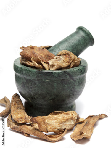 Organic Dried Mango (Mangifera indica) on marble pestle and over white background photo