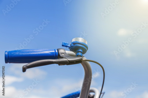 blue bicycle bell with blue grip on handle bar 