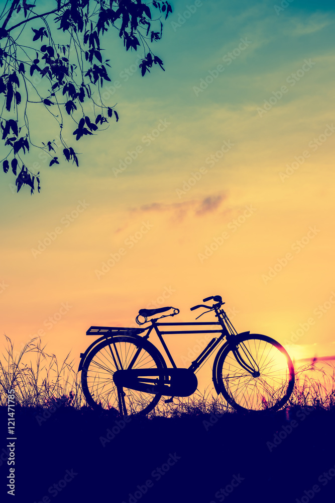 beautiful landscape image with Silhouette  Bicycle at sunset in