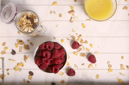 healthy breakfast with raspberry cereals and orange juice photo