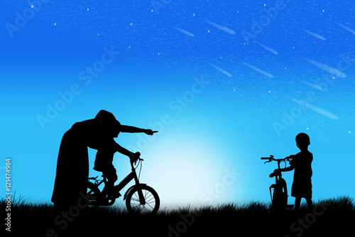 Silhouette of Mother teaching son biking